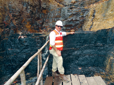 Cokal Chairman Peter Lynch in front of an outcrop of coking coal at the BBM  project. Cokal expects production at BBM to start in early 2015.